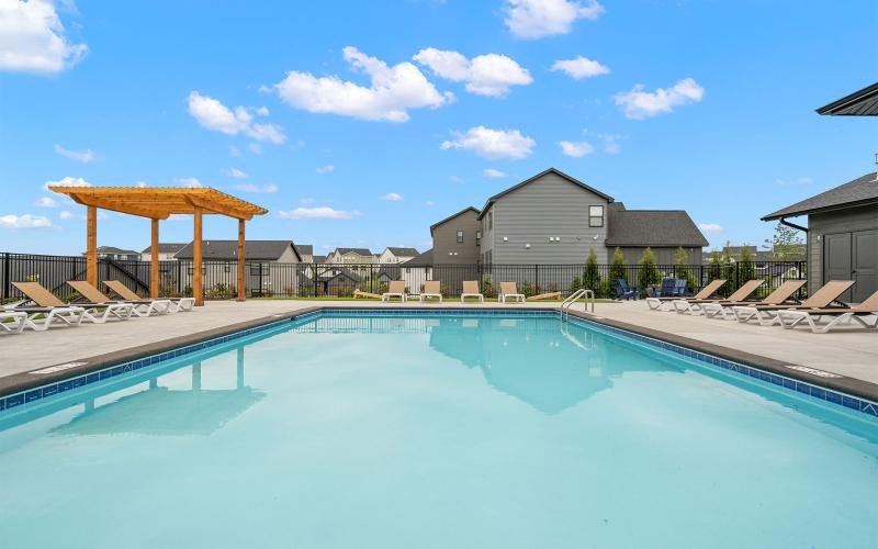 a swimming pool with chairs around it