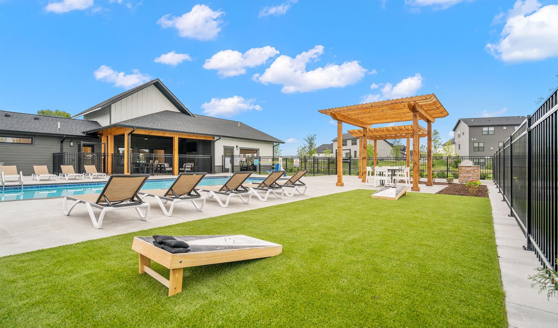 a backyard with a pool and chairs