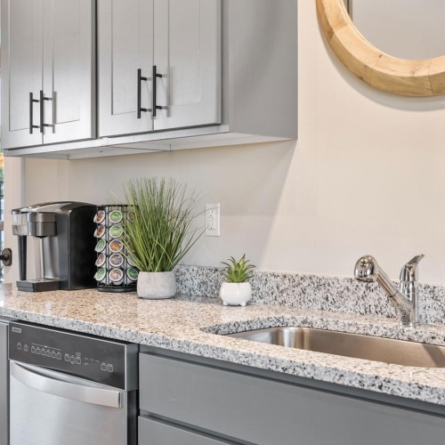 a kitchen with a sink and a mirror