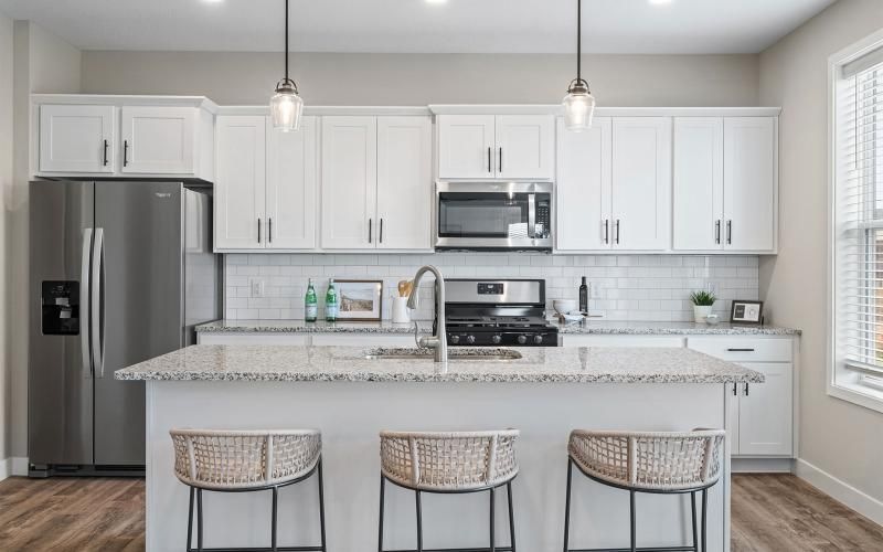 a kitchen with white cabinets